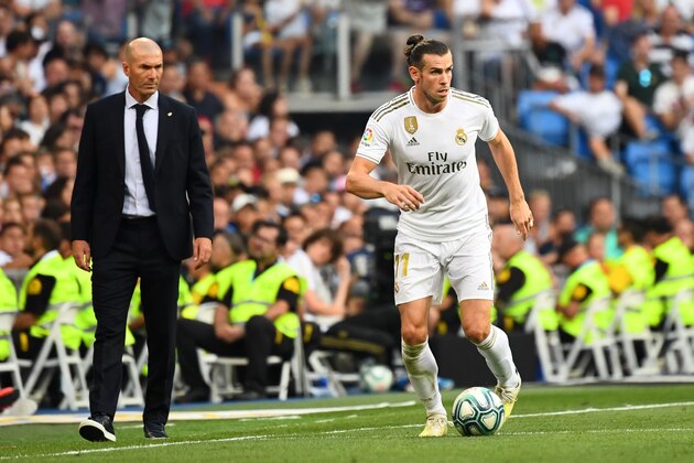 Real Madrid's French coach Zinedine Zidane (L) looks at Real Madrid's Welsh forward Gareth Bale (R) during the Spanish League football match between Real Madrid and Real Valladolid at the Santiago Bernabeu stadium in Madrid on August 24, 2019. (Photo by GABRIEL BOUYS / AFP)        (Photo credit should read GABRIEL BOUYS/AFP/Getty Images)