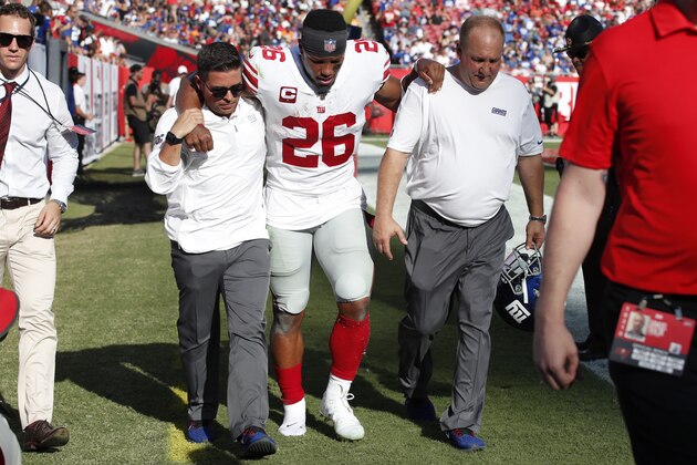 New York Giants running back Saquon Barkley (26) is helped off the field after hurting his ankle against the Tampa Bay Buccaneers during an NFL football game, Sunday, Sept. 22, 2019, in Tampa, Fla. The Giants won the game 32-31. (Jeff Haynes/AP Images for Panini)