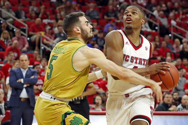 North Carolina State 's Dennis Smith Jr. (4) drives past Notre Dame's Matt Farrell (5) during the first half of an NCAA college basketball game in Raleigh, N.C., Saturday, Feb. 18, 2017. (AP Photo/Karl B DeBlaker)