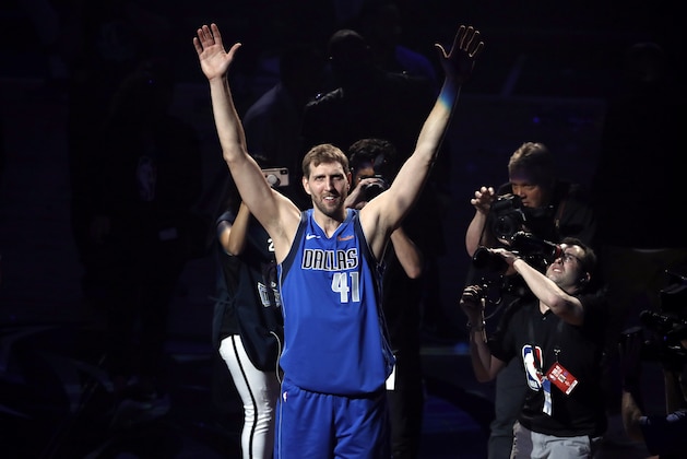 Dallas Mavericks' Dirk Nowitzki acknowledges cheers from fans as he walks off the court following the team's NBA basketball game against the Phoenix Suns in Dallas, Tuesday, April 9, 2019. The team honored Nowitkzi, who played his final home game of his 21-year career. (AP Photo/Tony Gutierrez)
