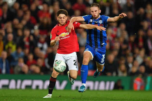 Manchester United's Welsh midfielder Daniel James (L) vies with Rochdale's Welsh defender Rhys Norrington-Davies (R) during the English League Cup third round football match between Manchester United and Rochdale at Old Trafford in Manchester, north-west England on September 25, 2019. (Photo by Paul ELLIS / AFP) / RESTRICTED TO EDITORIAL USE. No use with unauthorized audio, video, data, fixture lists, club/league logos or 'live' services. Online in-match use limited to 120 images. An additional 40 images may be used in extra time. No video emulation. Social media in-match use limited to 120 images. An additional 40 images may be used in extra time. No use in betting publications, games or single club/league/player publications. /         (Photo credit should read PAUL ELLIS/AFP/Getty Images)