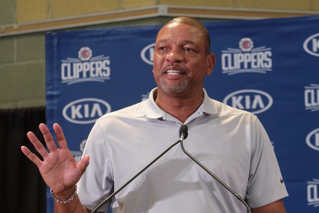 From left, Los Angeles Clippers head coach Doc Rivers introduces Paul George and Kawhi Leonard at a press conference at the Green Meadows Recreation Center in Los Angeles, Wednesday, July 23, 2019. (AP Photo/Ringo H.W. Chiu)