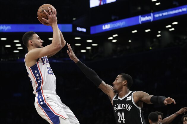 Philadelphia 76ers' Ben Simmons (25) shoots over Brooklyn Nets' Rondae Hollis-Jefferson (24) in the first quarter of an NBA basketball game, Sunday, Nov. 25, 2018, in New York. (AP Photo/Mark Lennihan)