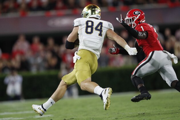 Notre Dame tight end Cole Kmet (84) runs against Georgia defensive back Divaad Wilson (1) during the first half of an NCAA college football game, Saturday, Sept. 21, 2019, in Athens, Ga. (AP Photo/John Bazemore)