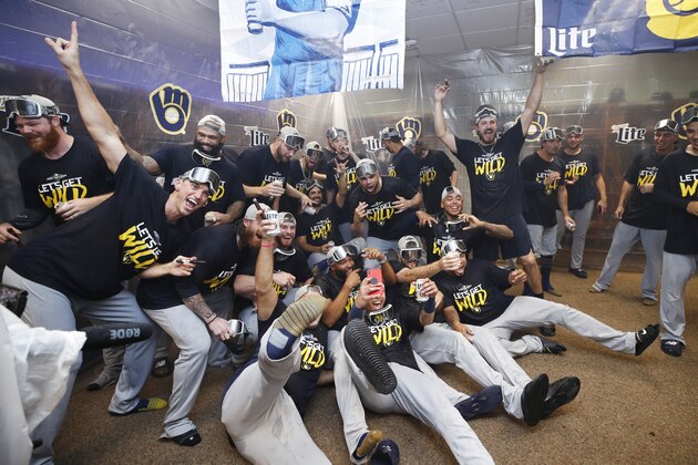 CINCINNATI, OH - SEPTEMBER 25: Milwaukee Brewers players celebrate in the clubhouse after clinching a playoff berth following a 9-2 win over the Cincinnati Reds at Great American Ball Park on September 25, 2019 in Cincinnati, Ohio. (Photo by Joe Robbins/Getty Images)