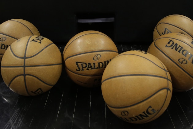 A logo for the NBA playoffs and official basketballs are seen on the court prior to Game 1 of an NBA basketball playoffs basketball game between the Los Angeles Lakers and San Antonio Spurs, Sunday, April 21, 2013, in San Antonio, Texas. (AP Photo/Eric Gay)