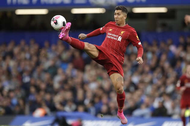 Liverpool's Roberto Firmino reaches for the ball during the British premier League soccer match between Chelsea and Liverpool, at the Stamford Bridge Stadium, London, Sunday, Sept. 22, 2019. (AP Photo/Matt Dunham)