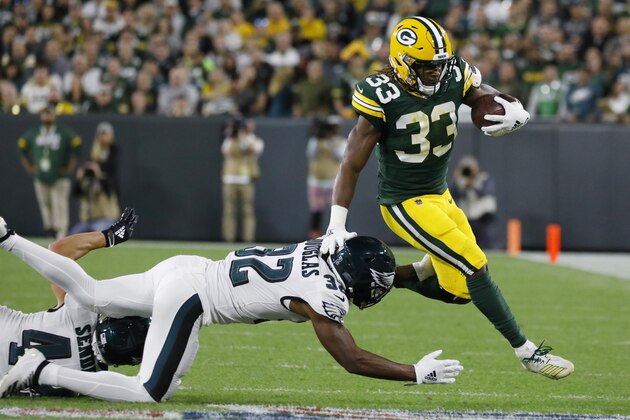 Green Bay Packers running back Aaron Jones breaks the tackle of Philadelphia Eagles cornerback Rasul Douglas during the first half of an NFL football game Thursday, Sept. 26, 2019, in Green Bay, Wis. (AP Photo/Jeffrey Phelps)