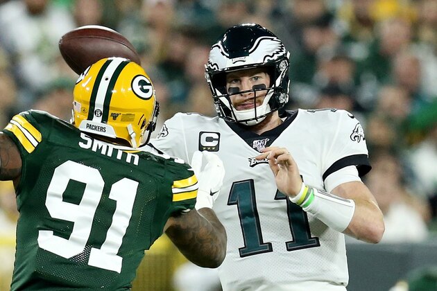 GREEN BAY, WISCONSIN - SEPTEMBER 26:  Carson Wentz #11 of the Philadelphia Eagles throws a pass while being pressured by Preston Smith #91 of the Green Bay Packers in the first quarter at Lambeau Field on September 26, 2019 in Green Bay, Wisconsin. (Photo by Dylan Buell/Getty Images)