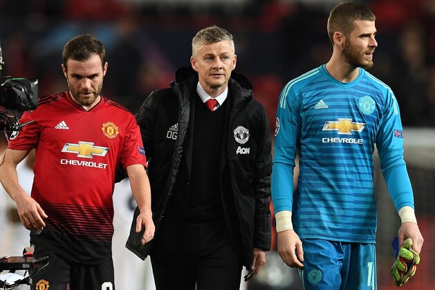 Manchester United's  Norwegian caretaker manager Ole Gunnar Solskjaer (C) leaves the pitch with Manchester United's Spanish midfielder Juan Mata (L) and Manchester United's Spanish goalkeeper David de Gea after the first leg of the UEFA Champions League round of 16 football match between Manchester United and Paris Saint-Germain (PSG) at Old Trafford in Manchester, north-west England on February 12, 2019. - PSG won the match 2-0. (Photo by Paul ELLIS / AFP)        (Photo credit should read PAUL ELLIS/AFP/Getty Images)