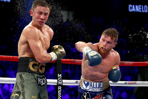 LAS VEGAS, NV - SEPTEMBER 16:  (R-L) Canelo Alvarez throws a punch at Gennady Golovkin during their WBC, WBA and IBF middleweight championship bout at T-Mobile Arena on September 16, 2017 in Las Vegas, Nevada.  (Photo by Al Bello/Getty Images)