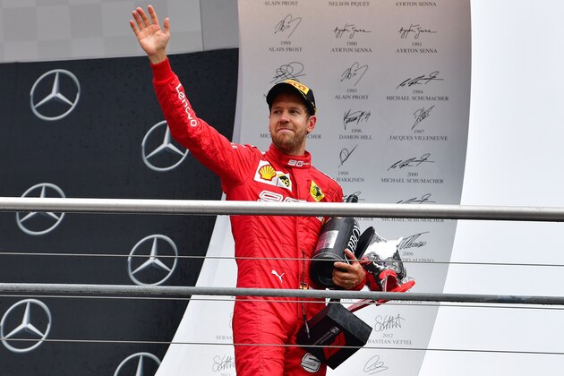 Second placed Ferrari's German driver Sebastian Vettel celebrates with his trophy after the German Formula One Grand Prix at the Hockenheim racing circuit on July 28, 2019 in Hockenheim, southern Germany. (Photo by Andrej ISAKOVIC / AFP)        (Photo credit should read ANDREJ ISAKOVIC/AFP/Getty Images)