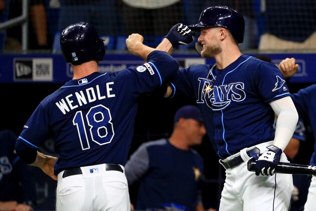 ST PETERSBURG, FLORIDA - SEPTEMBER 25: Joey Wendle #18 of the Tampa Bay Rays is congratulated after hitting a home run in the first inning by Austin Meadows #17 during a game against the New York Yankees at Tropicana Field on September 25, 2019 in St Petersburg, Florida. (Photo by Mike Ehrmann/Getty Images)