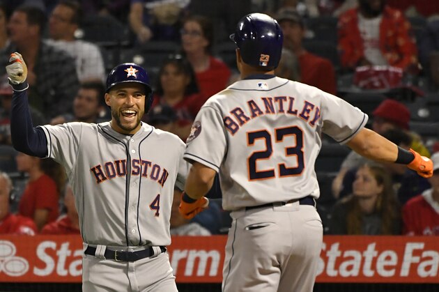 ANAHEIM, CA - SEPTEMBER 27: George Springer #4 of the Houston Astros congratulates Michael Brantley #23 after he hit a three run home run against pitcher Luis Garcia #40 of the Los Angeles Angels in the eighth inning at Angel Stadium of Anaheim on September 27, 2019 in Anaheim, California. (Photo by John McCoy/Getty Images)