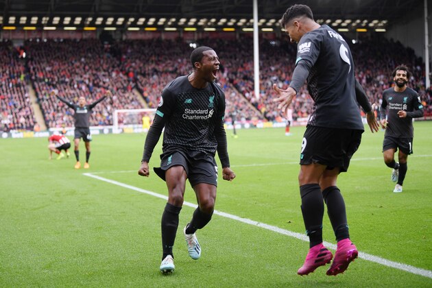 SHEFFIELD, ENGLAND - SEPTEMBER 28:  Georginio Wijnaldum of Liverpool celebrates with teammate Roberto Firmino after scoring his team's first goal during the Premier League match between Sheffield United and Liverpool FC at Bramall Lane on September 28, 2019 in Sheffield, United Kingdom. (Photo by Laurence Griffiths/Getty Images)
