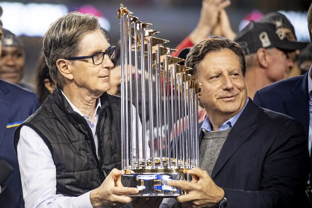 LOS ANGELES, CA - OCTOBER 28: Boston Red Sox Principal Owner John Henry and Chairman Tom Werner hold up the World Series trophy after winning the 2018 World Series in game five against the Los Angeles Dodgers on October 28, 2018 at Dodger Stadium in Los Angeles, California. (Photo by Billie Weiss/Boston Red Sox/Getty Images)