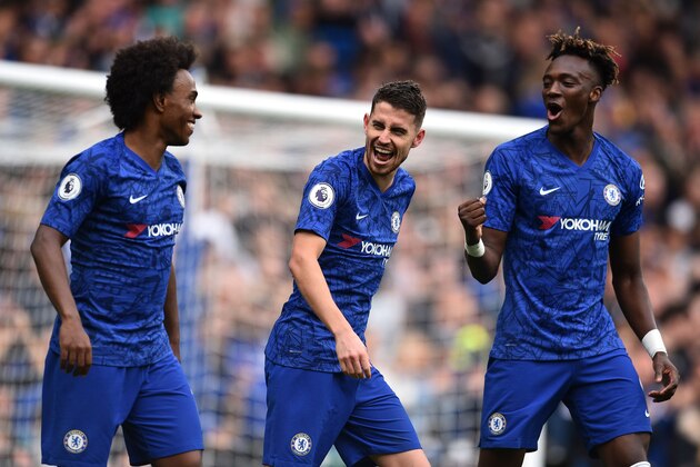 Chelsea's Italian midfielder Jorginho (L) celebrates scoring the opening goal from the penalty spot with Chelsea's English striker Tammy Abraham (R) and Chelsea's Brazilian midfielder Willian (L) during the English Premier League football match between Chelsea and Brighton and Hove Albion at Stamford Bridge in London on September 28, 2019. (Photo by Glyn KIRK / AFP) / RESTRICTED TO EDITORIAL USE. No use with unauthorized audio, video, data, fixture lists, club/league logos or 'live' services. Online in-match use limited to 120 images. An additional 40 images may be used in extra time. No video emulation. Social media in-match use limited to 120 images. An additional 40 images may be used in extra time. No use in betting publications, games or single club/league/player publications. /         (Photo credit should read GLYN KIRK/AFP/Getty Images)