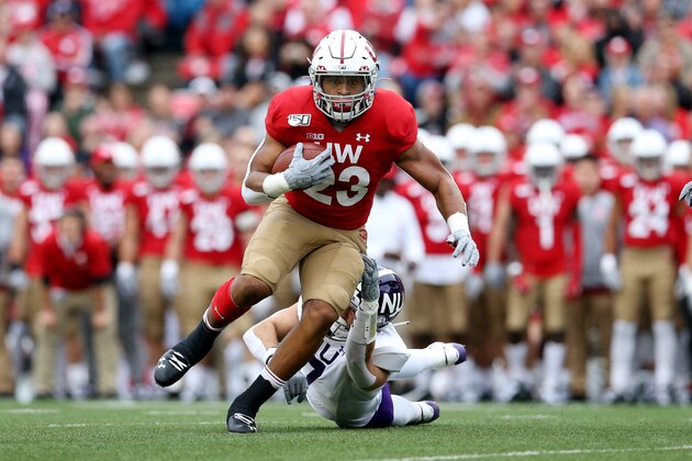 MADISON, WISCONSIN - SEPTEMBER 28:  Jonathan Taylor #23 of the Wisconsin Badgers runs with the ball while being tackled by Travis Whillock #7 of the Northwestern Wildcats in the first quarter at Camp Randall Stadium on September 28, 2019 in Madison, Wisconsin. (Photo by Dylan Buell/Getty Images)