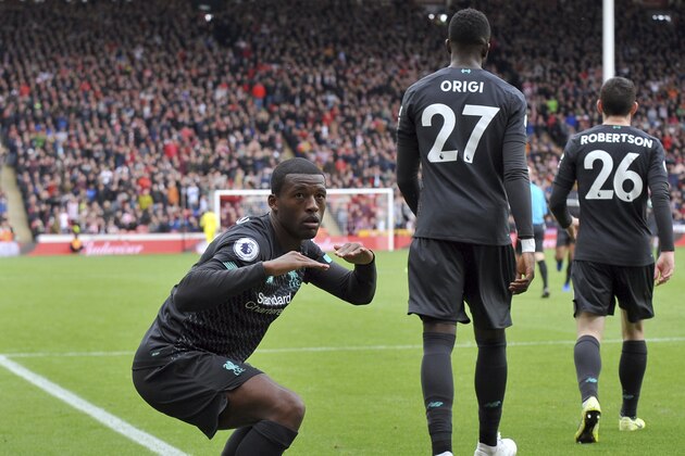 Liverpool's Georginio Wijnaldum, left, celebrates after scoring his side's opening goal during the English Premier League soccer match between Sheffield United and Liverpool at Bramall Lane in Sheffield, England, Saturday, Sept. 28, 2019. (AP Photo/Rui Vieira)