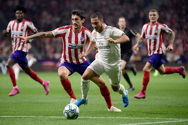 Atletico Madrid's Montenegrin defender Stefan Savic (L) vies with Real Madrid's Belgian forward Eden Hazard during the Spanish league football match between Club Atletico de Madrid and Real Madrid CF at the Wanda Metropolitano stadium in Madrid on September 28, 2019. (Photo by JAVIER SORIANO / AFP)        (Photo credit should read JAVIER SORIANO/AFP/Getty Images)