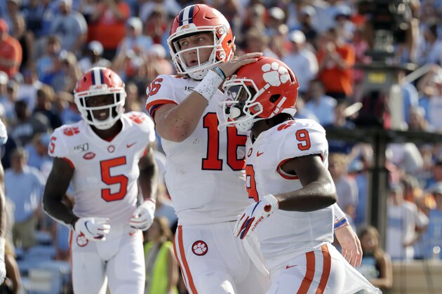Clemson's Travis Etienne (9) celebrates his touchdown with Trevor Lawrence (16) and Tee Higgins (5) during the second quarter of an NCAA college football game against North Carolina in Chapel Hill, N.C., Saturday, Sept. 28, 2019. (AP Photo/Chris Seward)