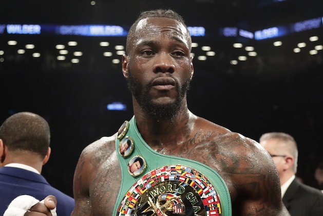 Deontay Wilder poses for photographs after the WBC heavyweight championship bout against Luis Ortiz on Saturday, March 3, 2018, in New York. Wilder won in the 10th round. (AP Photo/Frank Franklin II)