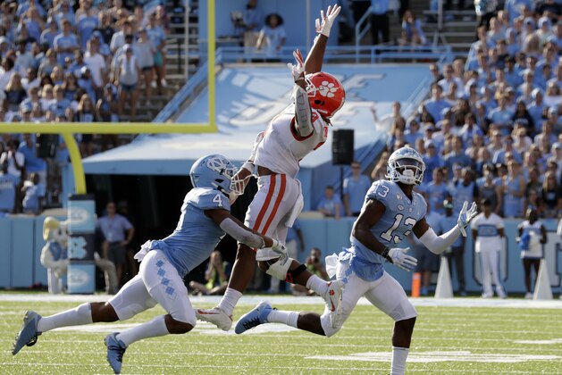 Clemson Tigers's Amari Rodgers (3) can't hang onto this pass as he's defended by North Carolina's Trey Morrison (4) and Tyler Davis (13) during the second quarter of an NCAA college football game in Chapel Hill, N.C., Saturday, Sept. 28, 2019. (AP Photo/Chris Seward)