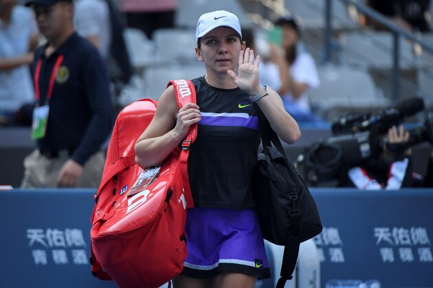 Simona Halep of Romania waves after her victory against Rebecca Peterson of Sweden in their women's singles first round match at the WTA China Open tennis tournament in Beijing on September 29, 2019. (Photo by WANG ZHAO / AFP)        (Photo credit should read WANG ZHAO/AFP/Getty Images)