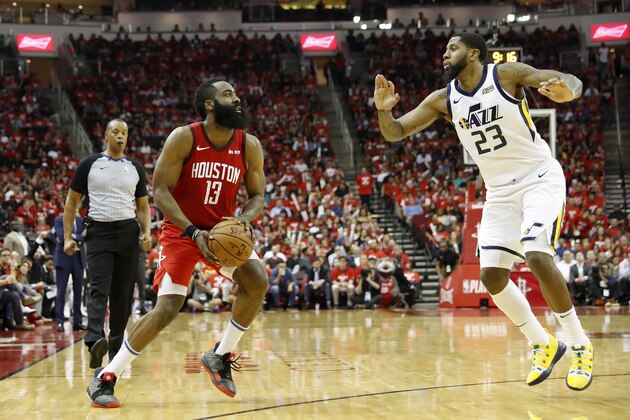 HOUSTON, TX - APRIL 24:  James Harden #13 of the Houston Rockets steps back for a three point shot defended by Royce O'Neale #23 of the Utah Jazz in the second half during Game Five of the first round of the 2019 NBA Western Conference Playoffs between the Houston Rockets and the Utah Jazz at Toyota Center on April 24, 2019 in Houston, Texas.  NOTE TO USER: User expressly acknowledges and agrees that, by downloading and or using this photograph, User is consenting to the terms and conditions of the Getty Images License Agreement.  (Photo by Tim Warner/Getty Images)