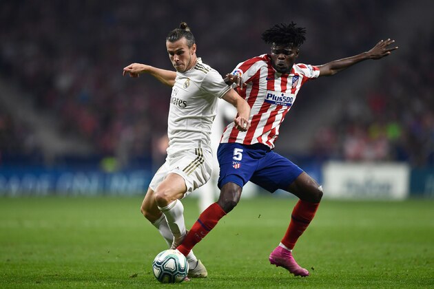Atletico Madrid's Ghanaian midfielder Thomas Partey (R) challeges Real Madrid's Welsh forward Gareth Bale during the Spanish league football match between Club Atletico de Madrid and Real Madrid CF at the Wanda Metropolitano stadium in Madrid on September 28, 2019. (Photo by OSCAR DEL POZO / AFP)        (Photo credit should read OSCAR DEL POZO/AFP/Getty Images)