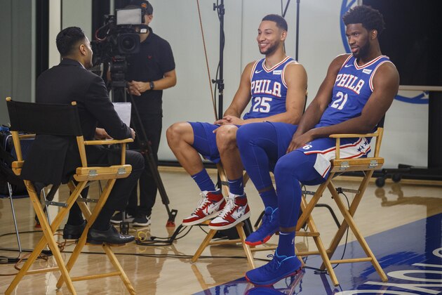 Philadelphia 76ers' Ben Simmons, left, and Joel Embiid, right, conduct interviews during media day at the NBA basketball team's practice facility, Monday, Sept. 30, 2019, in Camden. (AP Photo/Chris Szagola)