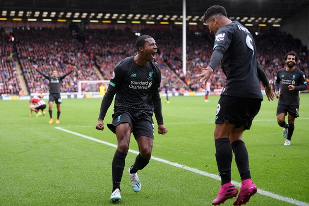 SHEFFIELD, ENGLAND - SEPTEMBER 28:  Georginio Wijnaldum of Liverpool celebrates with teammate after scoring his team's first goalduring the Premier League match between Sheffield United and Liverpool FC at Bramall Lane on September 28, 2019 in Sheffield, United Kingdom. (Photo by Laurence Griffiths/Getty Images)