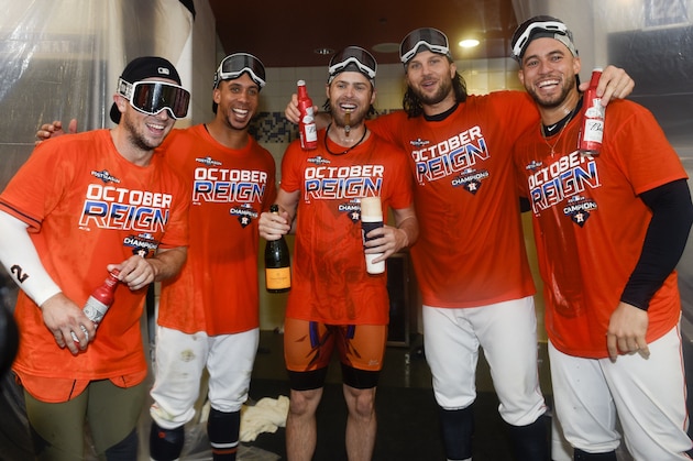 From left to right, Houston Astros' Alex Bregman, Michael Brantley, Josh Reddick, Jake Marisnick and George Springer celebrate their clinching of the AL West crown after a baseball game against the Los Angeles Angels, Sunday, Sept. 22, 2019, in Houston. (AP Photo/Eric Christian Smith)