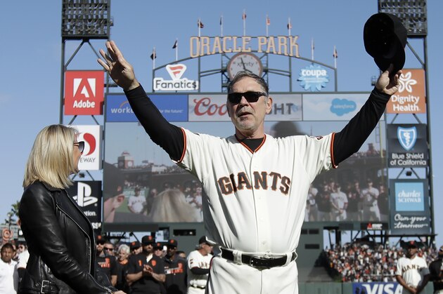 SAN FRANCISCO, CALIFORNIA - SEPTEMBER 29: Manager Bruce Bochy #15 of the San Francisco Giants, center, gestures toward fans next to his wife Kim during a ceremony honoring Bochy after a baseball game between the San Fransisco Giants and the Los Angeles Dodgers on September 29, 2019 in San Fransisco, California (Photo by Jeff Chiu - Pool/Getty Images)