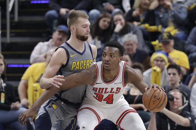 Chicago Bulls' Wendell Carter Jr. (34) is defended by Indiana Pacers' Domantas Sabonis during the first half of an NBA basketball game, Tuesday, Dec. 4, 2018, in Indianapolis. (AP Photo/Darron Cummings)