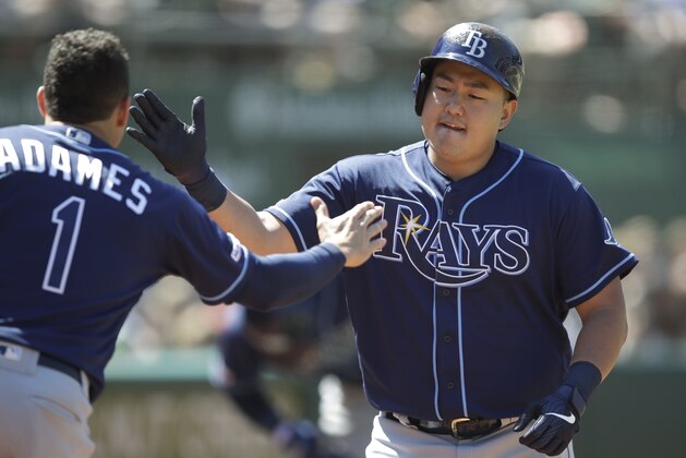 Tampa Bay Rays' Ji-Man Choi, right, is congratulated by Willy Adames (1) after hitting a home run off Oakland Athletics' Ryan Buchter during the seventh inning of a baseball game Saturday, June 22, 2019, in Oakland, Calif. (AP Photo/Ben Margot)