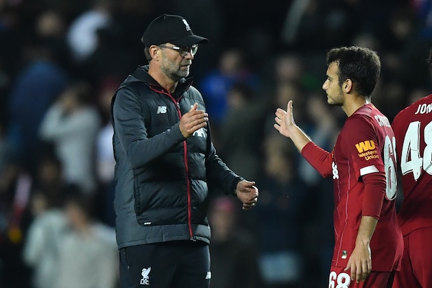 Liverpool's German manager Jurgen Klopp (L) reacts with Liverpool's Spanish midfielder Pedro Chirivella at the final whistle during the English League Cup third round football match between MK Dons and Liverpool at Stadium MK in Milton Keynes, Buckinghamshire on September 25, 2019. (Photo by Ben STANSALL / AFP) / RESTRICTED TO EDITORIAL USE. No use with unauthorized audio, video, data, fixture lists, club/league logos or 'live' services. Online in-match use limited to 120 images. An additional 40 images may be used in extra time. No video emulation. Social media in-match use limited to 120 images. An additional 40 images may be used in extra time. No use in betting publications, games or single club/league/player publications. /         (Photo credit should read BEN STANSALL/AFP/Getty Images)