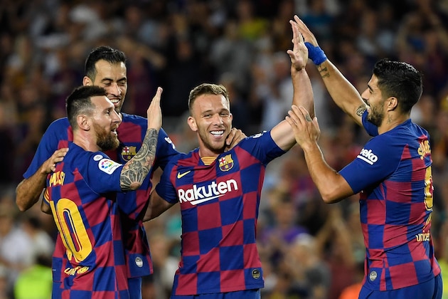 Barcelona's Brazilian midfielder Arthur (C) is congratulated by teammates Barcelona's Argentine forward Lionel Messi (L) and Barcelona's Uruguayan forward Luis Suarez (R) after scoring the second goal during the Spanish league football match between FC Barcelona and Villarreal CF at the Camp Nou stadium in Barcelona, on September 24, 2019. (Photo by LLUIS GENE / AFP)        (Photo credit should read LLUIS GENE/AFP/Getty Images)