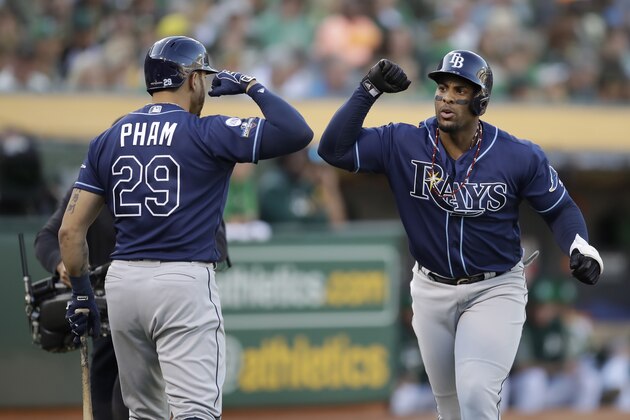 Tampa Bay Rays' Yandy Diaz, right, is congratulated by Tommy Pham after hitting a solo home run against the Oakland Athletics during the first inning of an American League wild-card baseball game in Oakland, Calif., Wednesday, Oct. 2, 2019. (AP Photo/Ben Margot)
