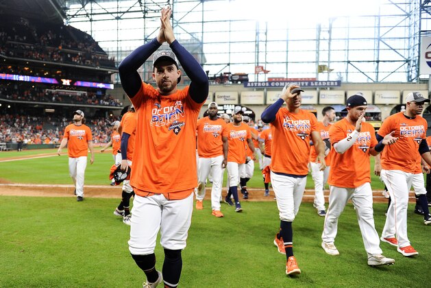 Houston Astros' George Springer, left, celebrates the team's clinching of the AL West crown after a baseball game against the Los Angeles Angels, Sunday, Sept. 22, 2019, in Houston. (AP Photo/Eric Christian Smith)