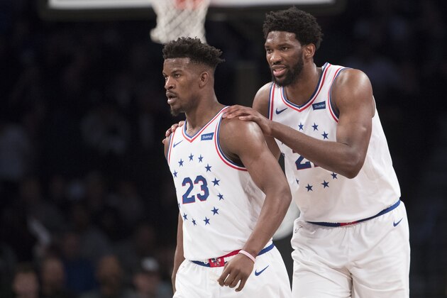 Philadelphia 76ers guard Jimmy Butler (23) and center Joel Embiid (21) talk during the second half of Game 4 of a first-round NBA basketball playoff series against the Brooklyn Nets, Saturday, April 20, 2019, in New York. The 76ers won 112-108. (AP Photo/Mary Altaffer)