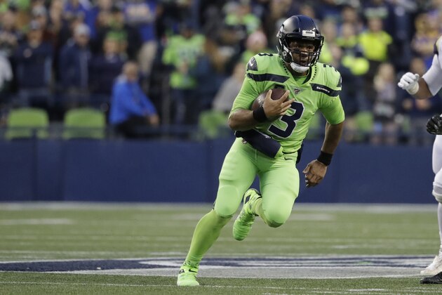 Seattle Seahawks quarterback Russell Wilson scrambles against the Los Angeles Rams during the first half of an NFL football game, Thursday, Oct. 3, 2019, in Seattle. (AP Photo/Elaine Thompson)