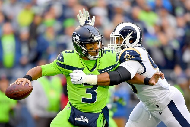 SEATTLE, WASHINGTON - OCTOBER 03: Russell Wilson #3 of the Seattle Seahawks is pressured by Aaron Donald #99 of the Los Angeles Rams during the first half of the game at CenturyLink Field on October 03, 2019 in Seattle, Washington. (Photo by Alika Jenner/Getty Images)