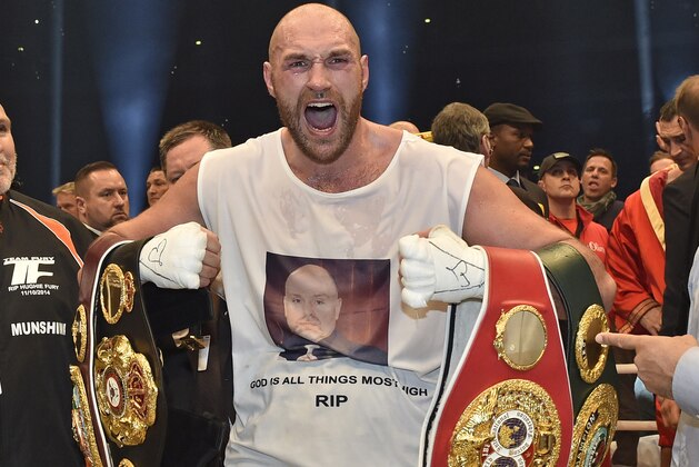 FILE - In this Nov. 29, 2015 file photo, Britain's new world champion Tyson Fury, celebrates with the WBA, IBF, WBO and IBO belts after winning the world heavyweight title fight against Ukraine's Wladimir Klitschko in Duesseldorf, western Germany.  Fury has vacated his WBO and WBA world titles to concentrate on his treatment and recovery from drug use and other personal issues.  Fury’s promotors released a statement early Thursday, Oct. 13, 2016,  confirming the decision. It comes in the wake of his second withdrawal from a rematch with Wladimir Klitschko after being declared