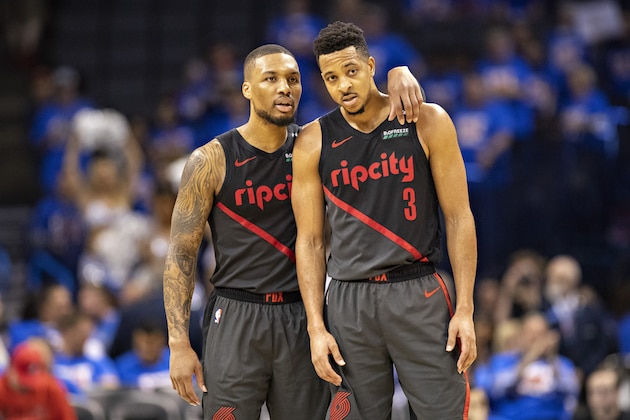 OKLAHOMA CITY, OK - APRIL 21: Damian Lillard #0 talks with CJ McCollum #3 of the Portland Trail Blazers during a game against the Oklahoma City Thunder during Round One Game Three of the 2019 NBA Playoffs on April 21, 2019 at Chesapeake Energy Arena in Oklahoma City, Oklahoma  NOTE TO USER: User expressly acknowledges and agrees that, by downloading and or using this photograph, User is consenting to the terms and conditions of the Getty Images License Agreement.  The Trail Blazers defeated the Thunder 111-98.  (Photo by Wesley Hitt/Getty Images)