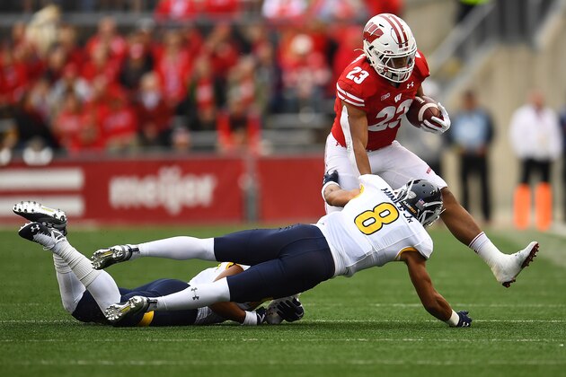 MADISON, WISCONSIN - OCTOBER 05:  Jonathan Taylor #23 of the Wisconsin Badgers is pursued by Elvis Hines #8 of the Kent State Golden Flashes during the first half at Camp Randall Stadium on October 05, 2019 in Madison, Wisconsin. (Photo by Stacy Revere/Getty Images)