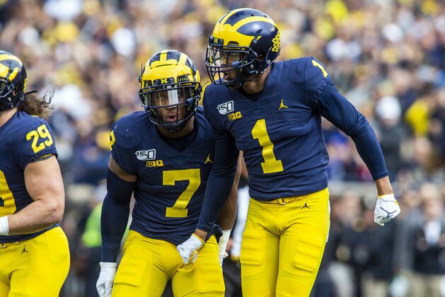 Michigan linebacker Khaleke Hudson (7) celebrates a fumble recovery by defensive back Ambry Thomas (1) in the first quarter of an NCAA college football game against Iowa in Ann Arbor, Mich., Saturday, Oct. 5, 2019. (AP Photo/Tony Ding)