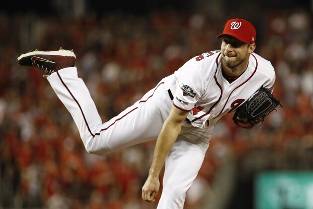 Washington Nationals starting pitcher Max Scherzer follows through on a pitch to the Milwaukee Brewers in the first inning of a National League wild card baseball game, Tuesday, Oct. 1, 2019, in Washington. (AP Photo/Patrick Semansky)