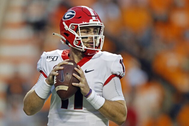 Georgia quarterback Jake Fromm (11) looks for a receiver in the first half of an NCAA college football game against Tennessee, Saturday, Oct. 5, 2019, in Knoxville, Tenn. (AP Photo/Wade Payne)