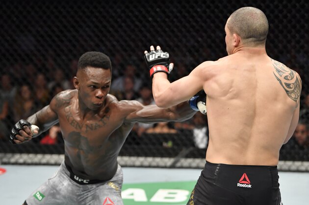 MELBOURNE, AUSTRALIA - OCTOBER 06:  (L-R) Israel Adesanya of Nigeria punches Robert Whittaker of New Zealand in their UFC middleweight championship fight during the UFC 243 event at Marvel Stadium on October 06, 2019 in Melbourne, Australia. (Photo by Jeff Bottari/Zuffa LLC/Zuffa LLC via Getty Images)